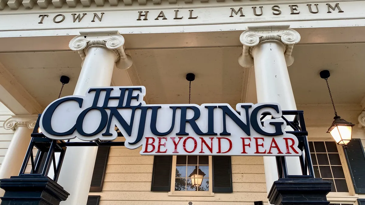 The Conjuring: Beyond Fear sign mounted on the columned Town Hall Museum building at Cedar Point