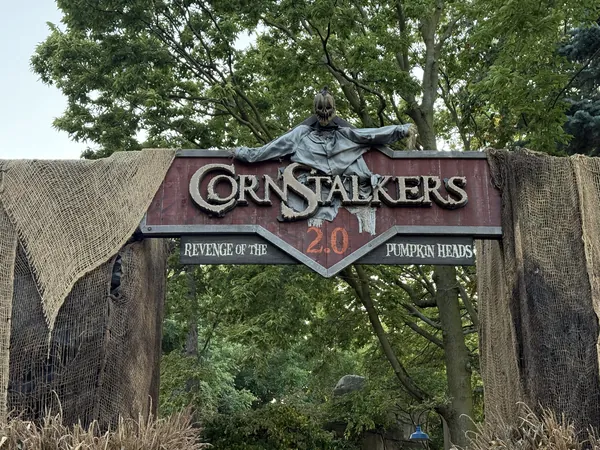 CornStalkers 2.0 Revenge of the Pumpkin Heads entrance arch at Cedar Point, draped in burlap and dried corn stalks