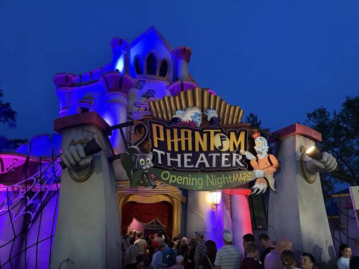 Phantom Theater: Opening Nightmare facade at Kings Island lit purple and blue at dusk on opening day