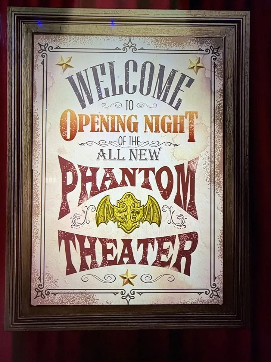 Framed vintage-style poster reading 'Welcome to Opening Night of the all new Phantom Theater' with bat illustration